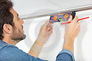 mason checking level house wall