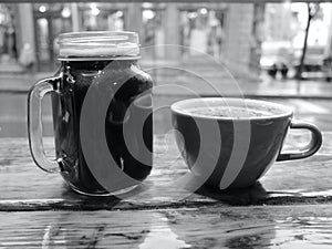 Mason Jar Coffee Mug and Classic Ceramic Coffee Cup on a Window Counter