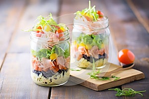 mason jar pasta salads, layered ingredients, on wooden background