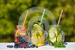 Mason jars of infused water with fruits
