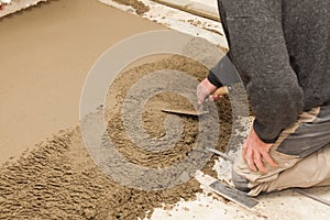 Mason leveling the cement screed