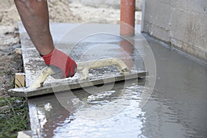 Mason leveling and screeding concrete floor base