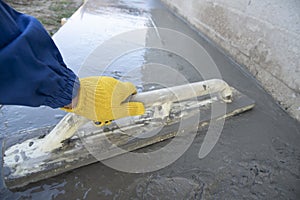 Mason leveling and screeding concrete floor base