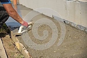 Mason leveling and screeding concrete floor base