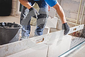 Mason plastering the concrete to build wall, Construction under building with mason plastering concrete to brick wall