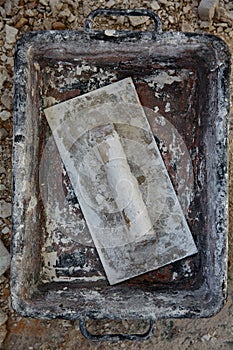 Mason tools on debris background