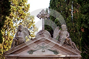 Masonic motives on the grave with children angels statues