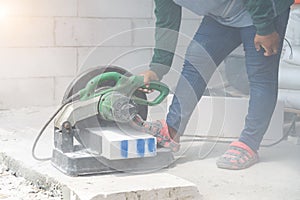 Masonry contractor using a dry circular tile or rock cutting saw