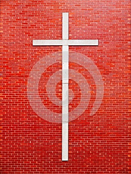 Masonry cross symbol against a red brick wall