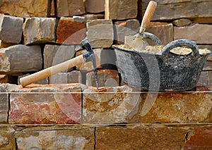 Masonry stone wall construction with tools
