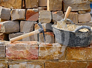 Masonry stone wall construction with tools