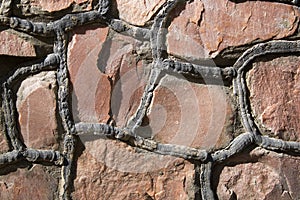 Masonry stone wall with irregular pattern, seamless texture or background