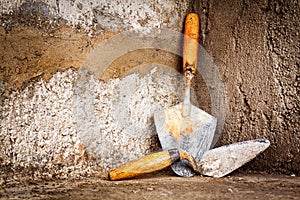 Masonry trowels on a concrete wall