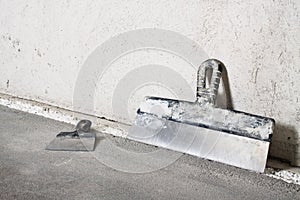 Masonry trowels and plaster wall