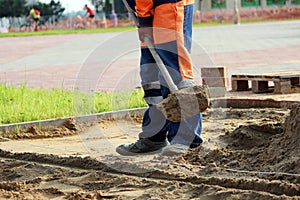 masons sand throw shovels for laying paving slabs in the town square