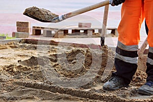 masons sand throw shovels for laying paving slabs in the town square