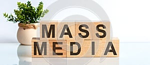 Mass Media word written on wood block. Faqs text on table, concept