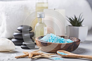 SPA concept: composition of spa treatment with natural sea salt, aromatic oil and flowers on wooden background, close up, top view