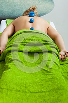 Massage with cupping glass in beautician