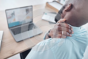 A massage is desperately needed. a businessman experiencing shoulder pain at work.