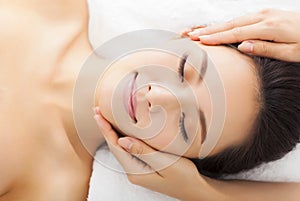 Massage of face for woman in spa