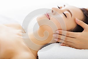 Massage of face for woman in spa