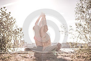 Massage girl demonstrates refreshing massaging methods in the forest.