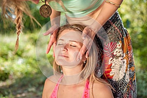 Massage girl gives her client a refreshing massage in the outdoors.