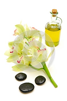 Massage oil and stones with orchids