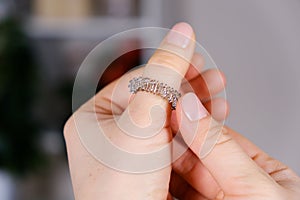 Massage ring for fingers in female hands close-up. Su Jok therapy, diagnosis and treatment of diseases, acupuncture and