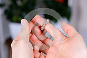 Massage ring for fingers in female hands close-up. Su Jok therapy, diagnosis and treatment of diseases, acupuncture and