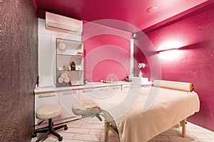 Massage room interior design in wellness and spa center. Dim lighting