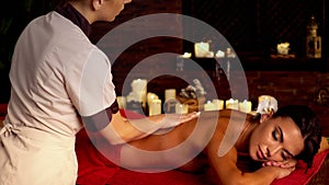 Massage in spa salon with woman and masseur.