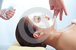 Massage therapist applying anti-aging cream