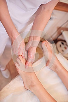 Massage therapist doing foot massage