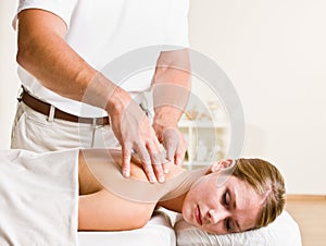 Massage therapist giving woman massage