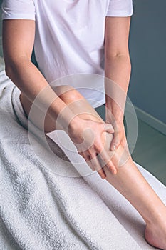 Massage therapist hands doing lymphatic drainage treatment to woman