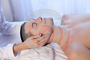 A massage therapist makes man medical back massage and body treatments at the Spa