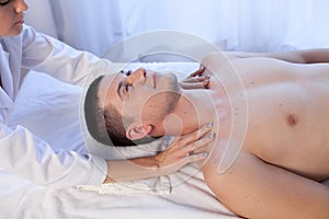 A massage therapist makes man medical back massage and body treatments at the Spa