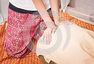 Massage therapist is massaging a women hip back