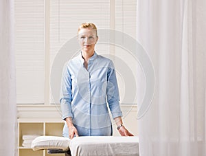 Massage therapist next to massage table