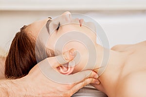 Massage therapist`s hands doing massage on head