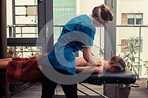 Massage therapist treating patient