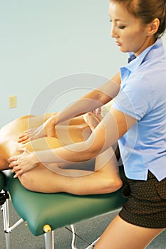 Massage therapy - therapist giving back massage