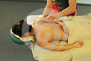 Massage therapy - therapist giving back massage