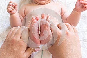 Massage time for newborn's tiny feet, Concept of a mother's healing touch
