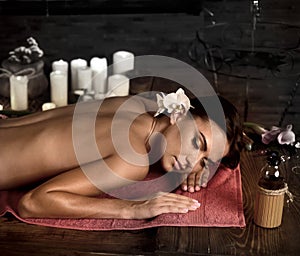 Massage of woman in spa salon. Luxary interior oriental therapy .