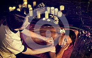 Massage of woman in spa salon. Luxary interior oriental therapy.