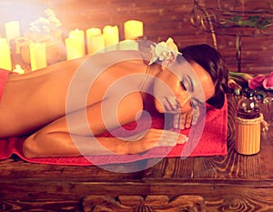Massage of woman in spa salon. Luxary interior oriental therapy.