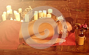 Massage of woman in spa salon. Luxary interior oriental therapy .